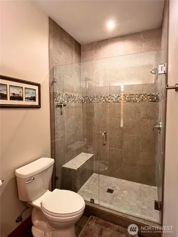 a bathroom with a toilet and a shower