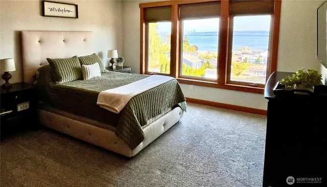 a bed sitting in a bedroom next to a window