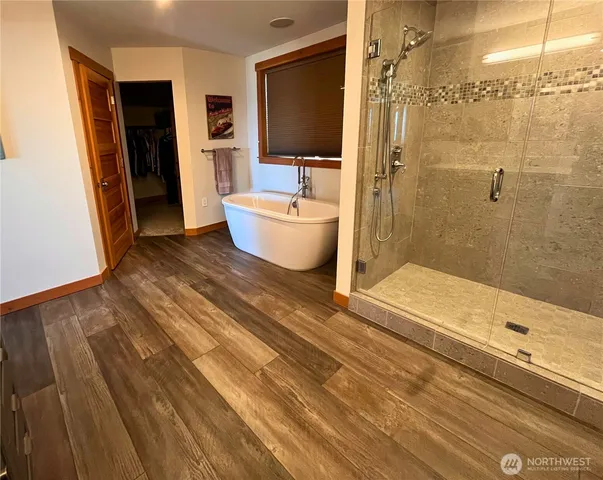 a bathroom with a bathtub and shower