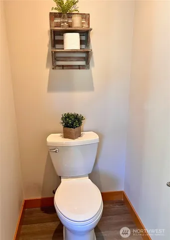 a white toilet sitting next to a small bathroom