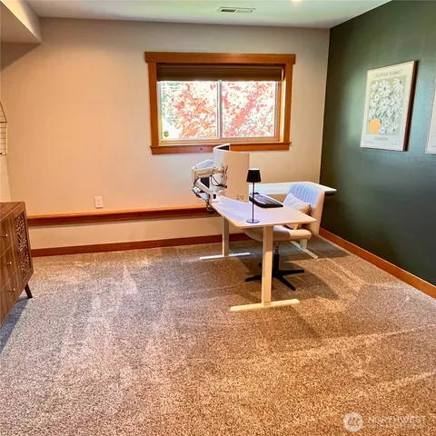 a bedroom with a bed and flat screen tv