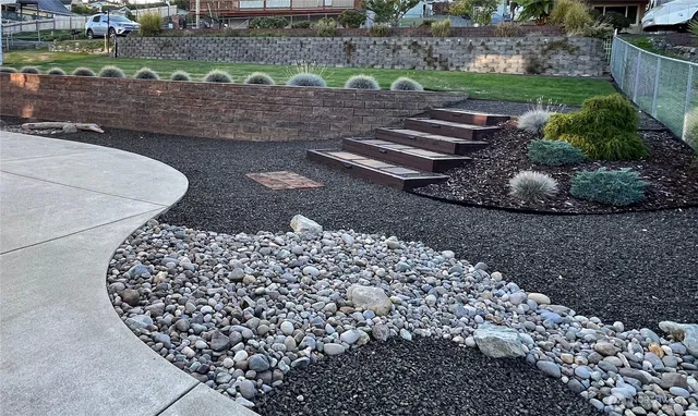 a view of a street with a house in the background