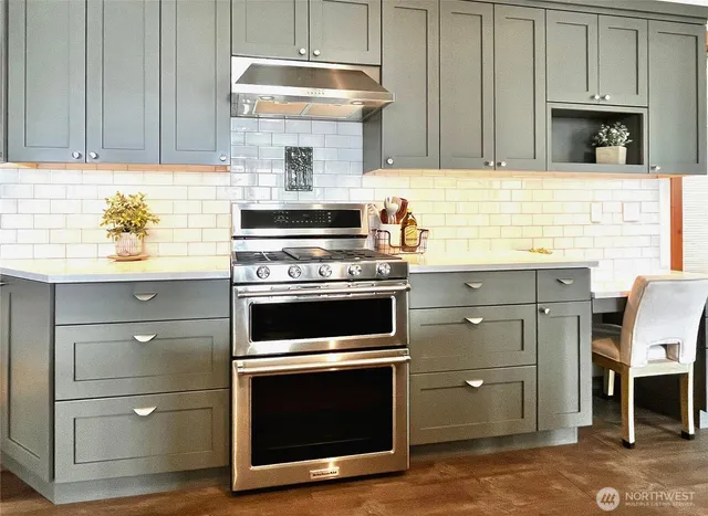 a kitchen with granite countertop wooden cabinets stainless steel appliances and a counter space