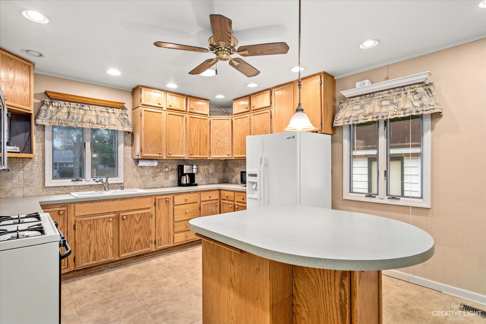 464 Davis Road Batavia, IL 60510 - Photo 6 of 17 a kitchen with stainless steel appliances granite countertop a sink a stove a refrigerator a microwave oven with white cabinets and wooden floor