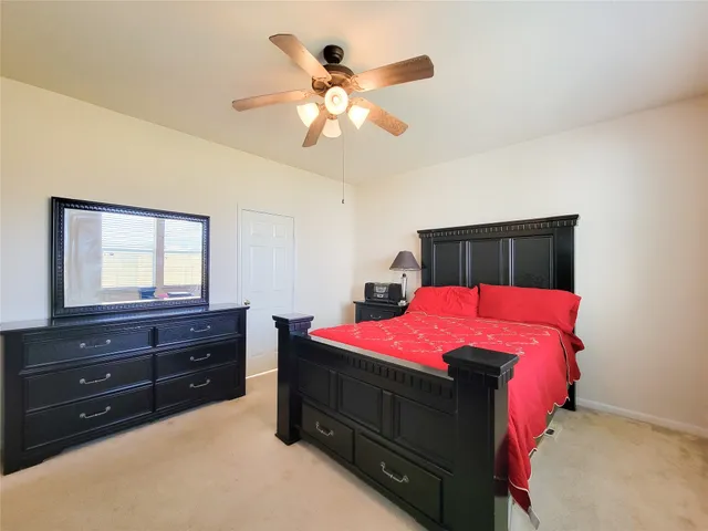 a bedroom with a bed and a dresser