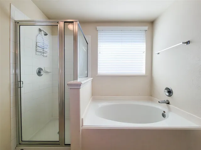 a white bath tub sitting next to a shower