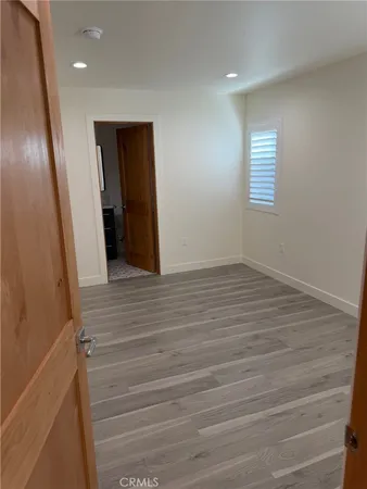 a view of hallway with wooden floor