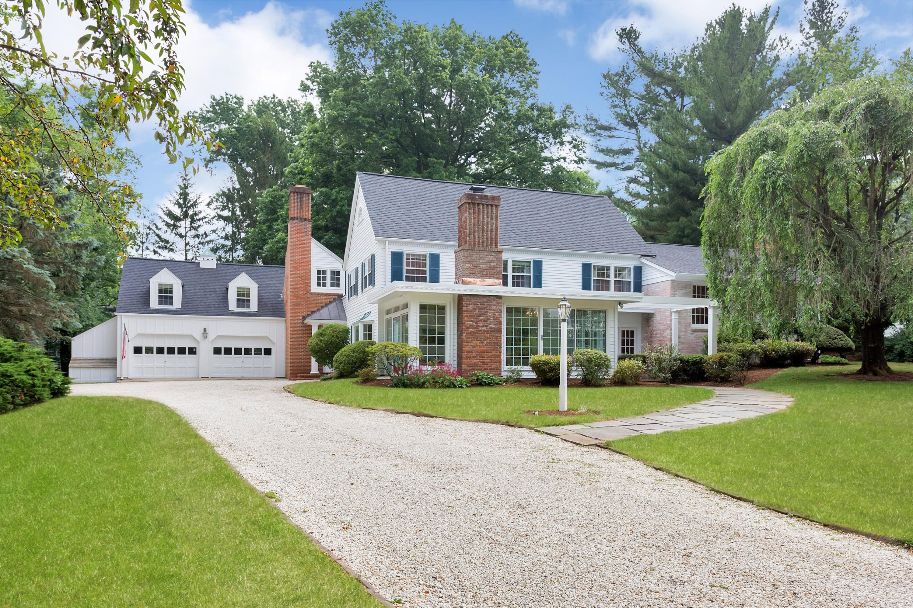 22 Saddle Ridge Road Darien, CT 06820 - Photo 1 of 37 a view of a house with a yard and large trees