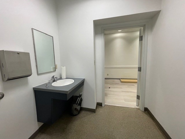 10 Hawthorne Place, Unit 106 Boston, MA 02114 - Photo 11 of 32 a bathroom with a sink a vanity and a mirror