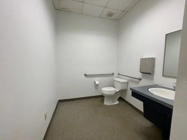 a room with lots of white furniture and plants