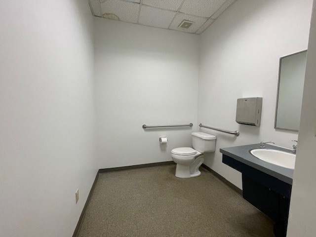 10 Hawthorne Place, Unit 106 Boston, MA 02114 - Photo 20 of 32 a white toilet sitting next to a bathroom sink