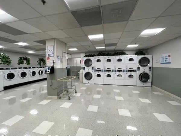 a dining room with furniture and a large window