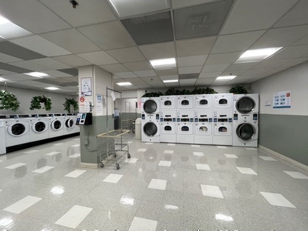 10 Hawthorne Place, Unit 106 Boston, MA 02114 - Photo 21 of 32 a room with lots of white furniture and plants