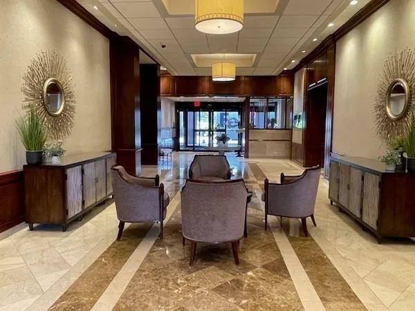 a view of a porch with furniture and floor to ceiling window