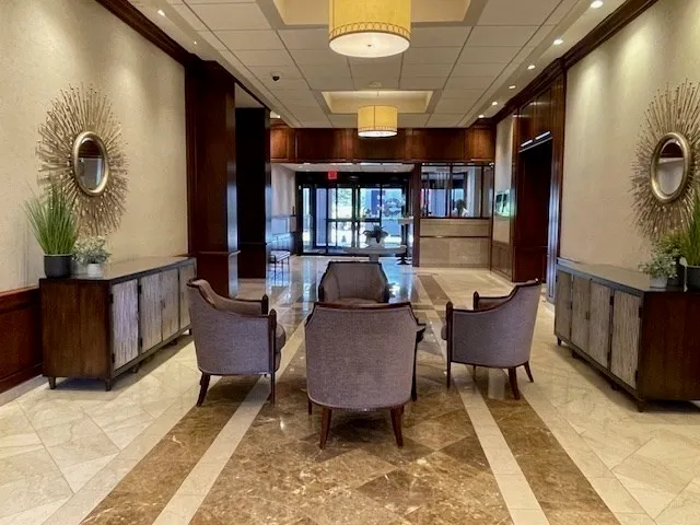 a view of a porch with furniture and floor to ceiling window