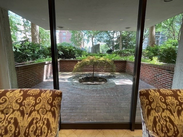 10 Hawthorne Place, Unit 106 Boston, MA 02114 - Photo 25 of 32 a view of a porch with furniture and floor to ceiling window
