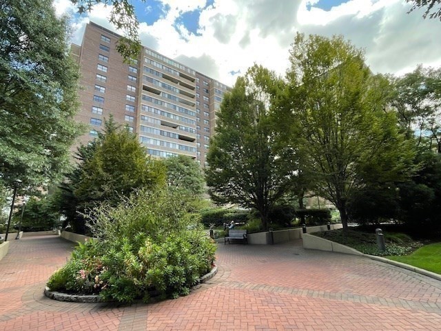 10 Hawthorne Place, Unit 106 Boston, MA 02114 - Photo 32 of 32 a view of a tall house with a yard and large trees