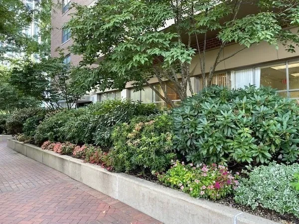 an empty room with wooden floor and mirror