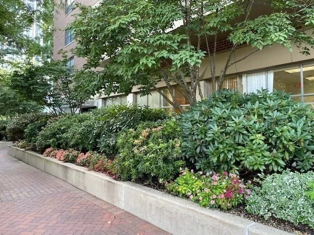 an empty room with wooden floor and mirror
