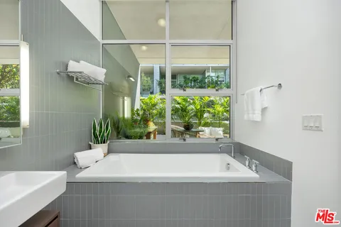 a white bath tub sitting next to a white sink