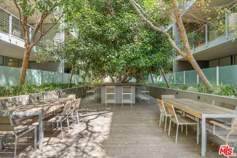 a view of a chairs and table in backyard of the house