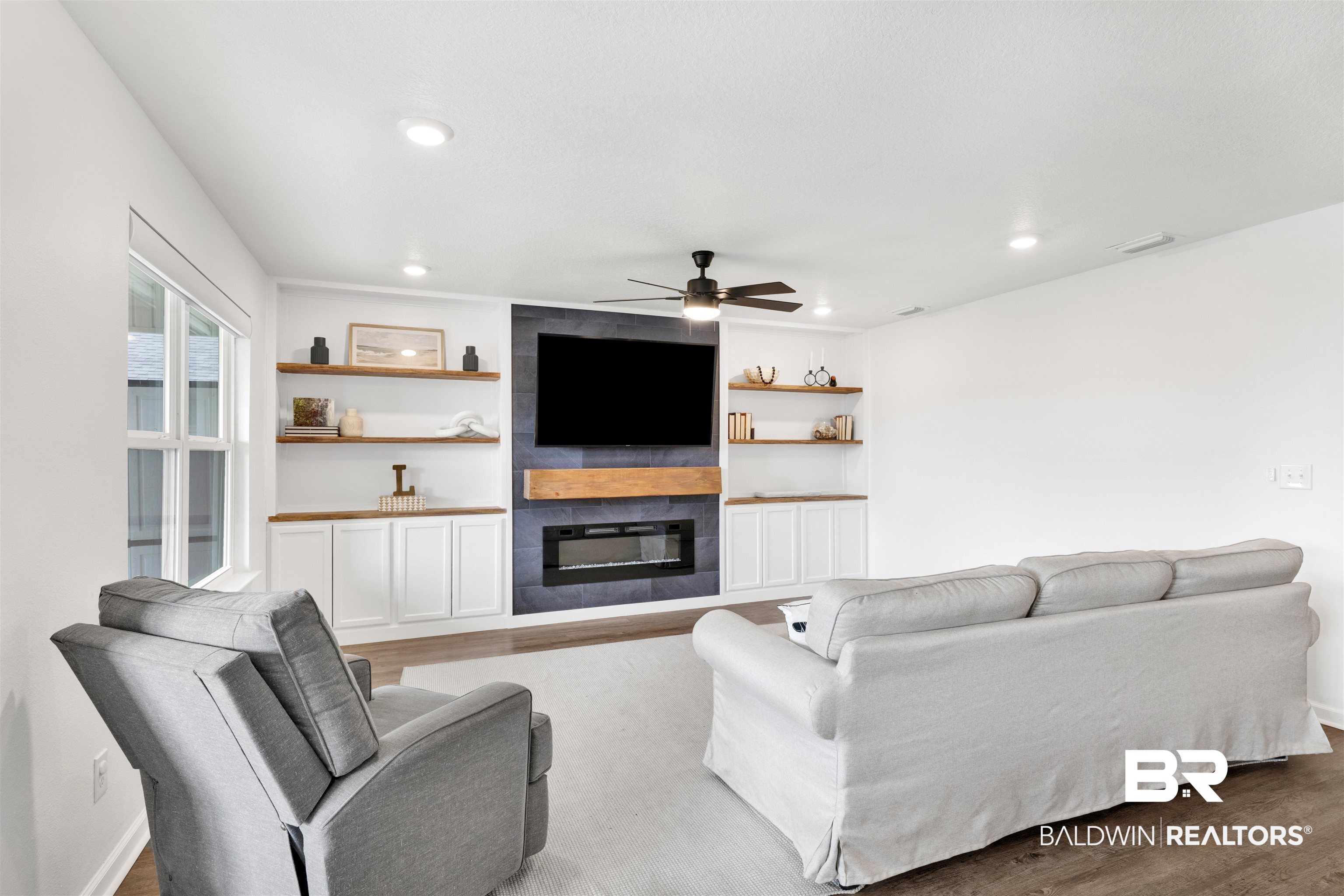 10763 Paget Drive North Mobile, AL 36608 - Photo 8 of 24 Living room with a fireplace, a ceiling fan, light wood-type flooring, built in shelves, and recessed lighting