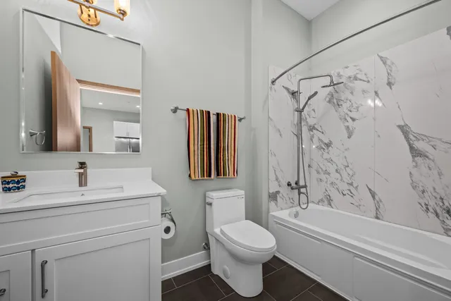 a utility room with dryer washer and a view of bedroom
