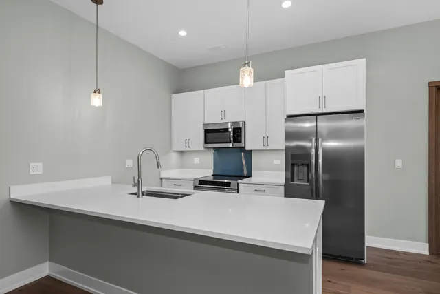 a large kitchen with a large window and stainless steel appliances