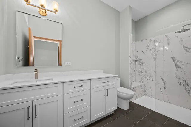 a bedroom with bed and a potted plant