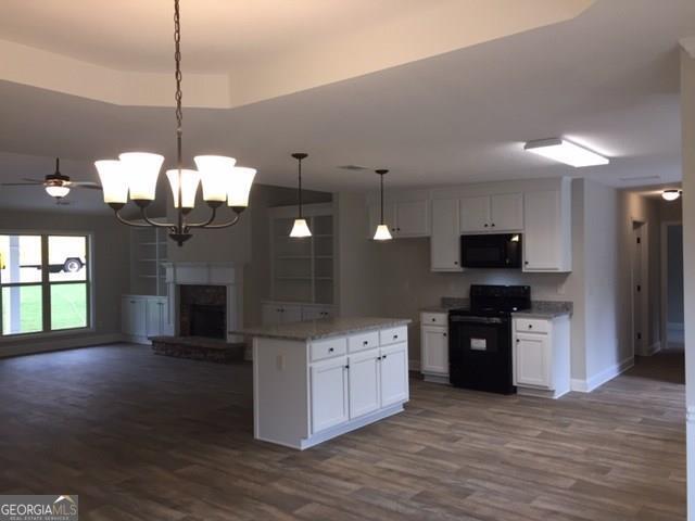 429 Riley Circle Northwest Milledgeville, GA 31061 - Photo 3 of 8 a kitchen with stainless steel appliances granite countertop a stove a sink and a wooden floor