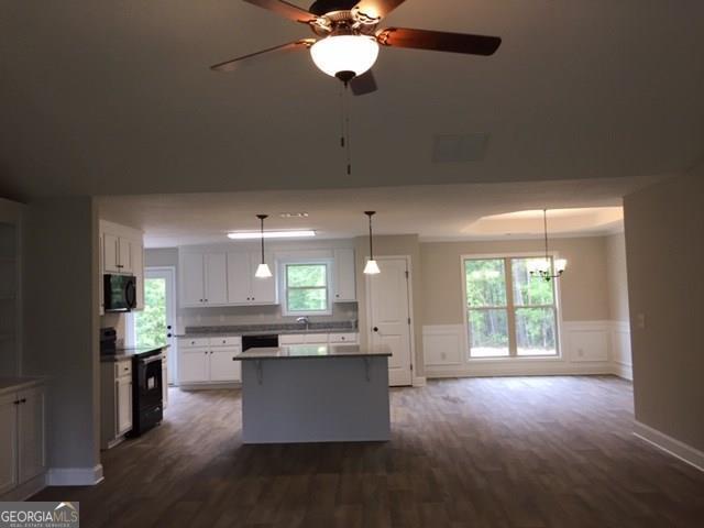 429 Riley Circle Northwest Milledgeville, GA 31061 - Photo 4 of 8 a open kitchen with kitchen island white cabinets and stainless steel appliances