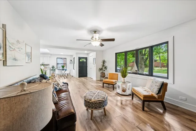 a living room with furniture and large windows