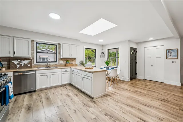 a kitchen with sink cabinets and wooden floor