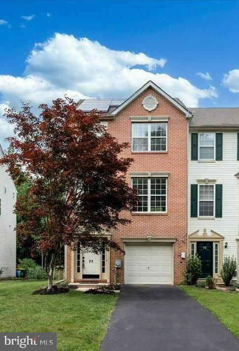a view of a big house with a yard and plants