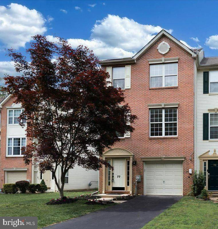 77 Wicklow Road Bear, DE 19701 - Photo 14 of 54 a front view of a house with a garden and trees