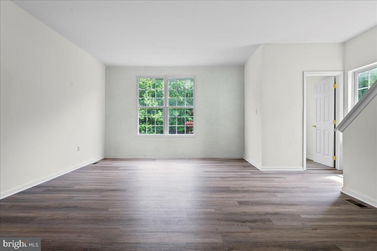77 Wicklow Road Bear, DE 19701 - Photo 19 of 54 an empty room with wooden floor and windows