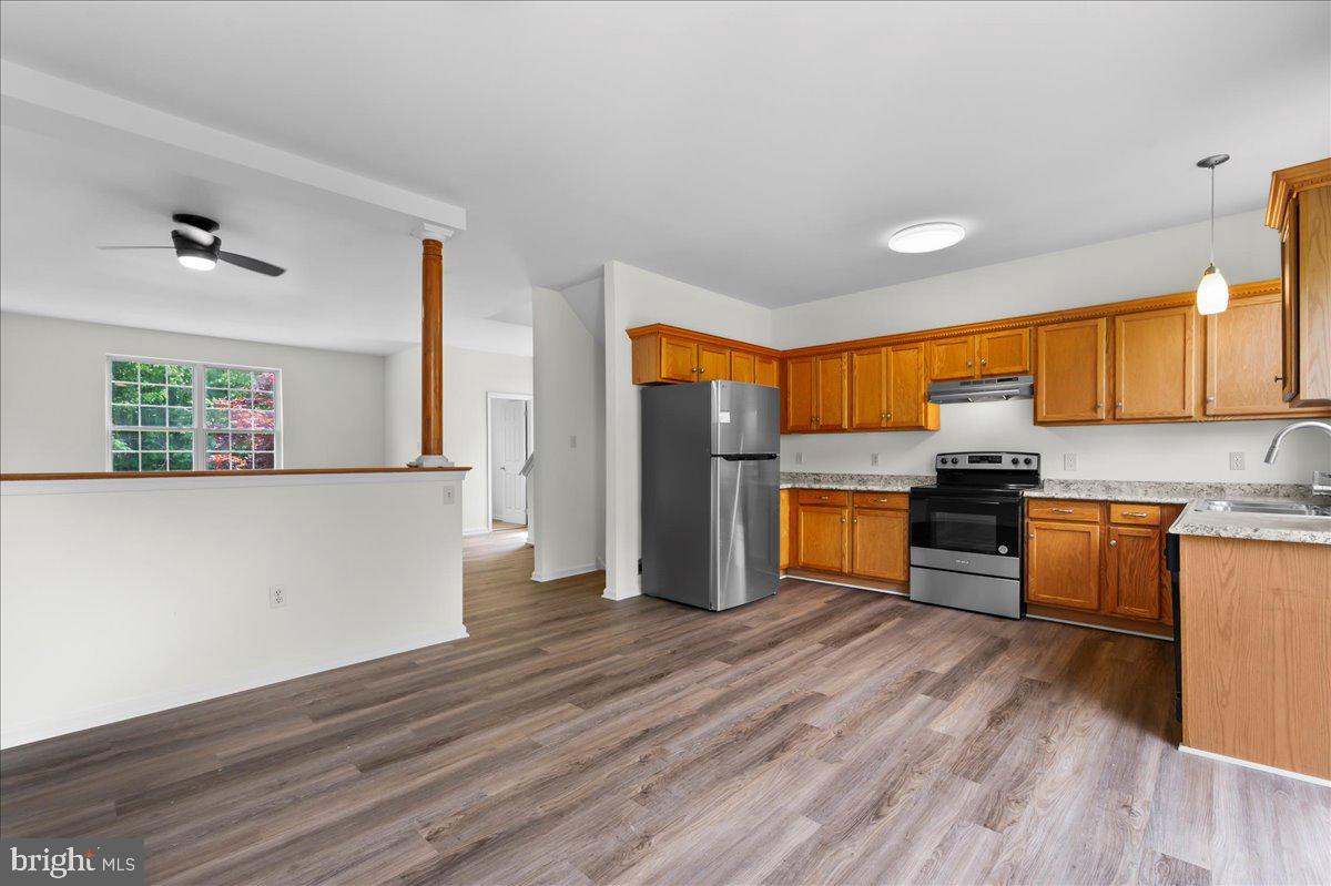 77 Wicklow Road Bear, DE 19701 - Photo 22 of 54 a kitchen with granite countertop wooden floors and stainless steel appliances