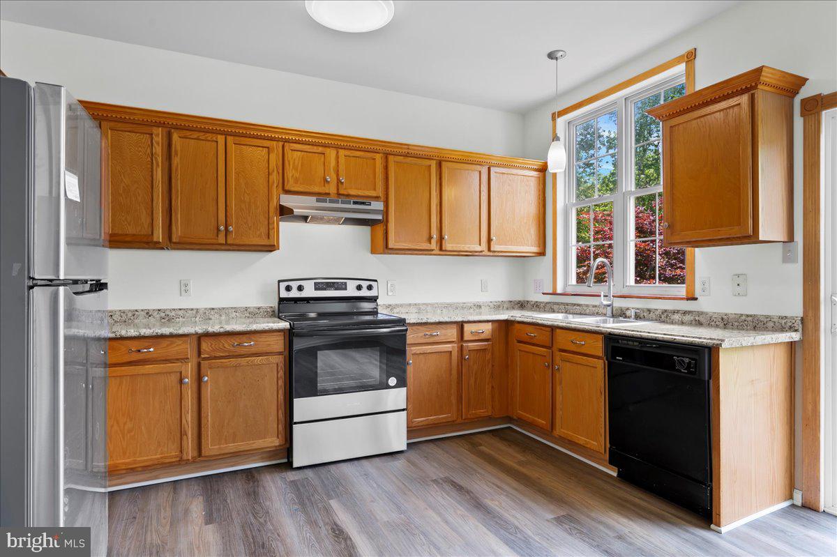 77 Wicklow Road Bear, DE 19701 - Photo 23 of 54 a kitchen with stainless steel appliances granite countertop a stove a sink and a microwave