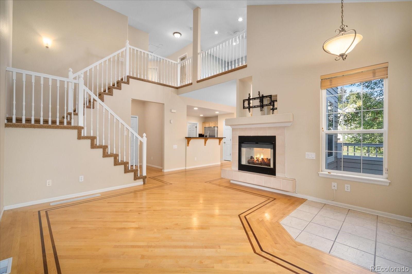 6115 Trailhead Road Highlands Ranch, CO 80130 - Photo 11 of 40 a view of an empty room with a fireplace and a window