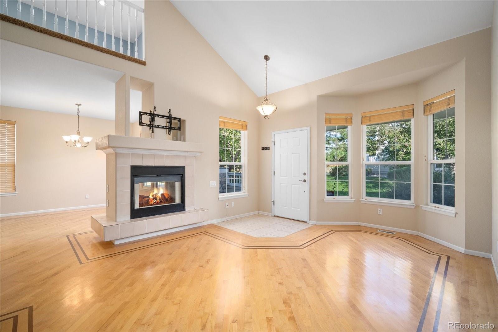 6115 Trailhead Road Highlands Ranch, CO 80130 - Photo 12 of 40 a view of an empty room with a fireplace and a window