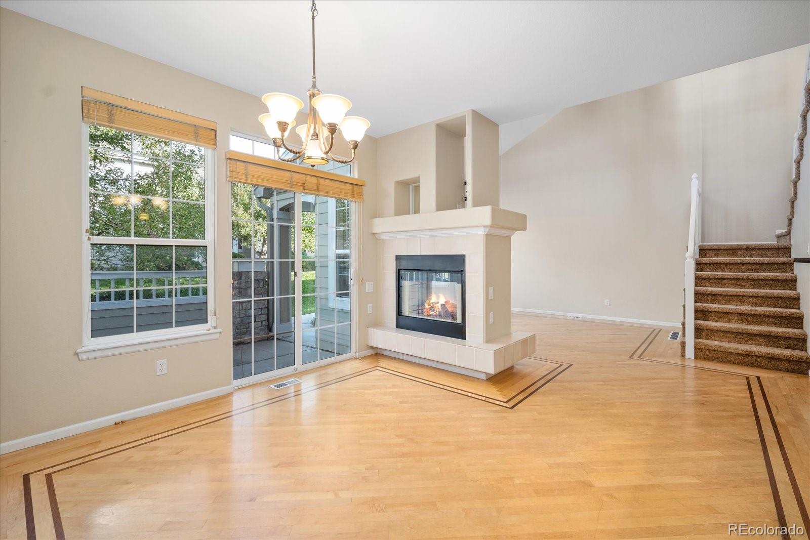6115 Trailhead Road Highlands Ranch, CO 80130 - Photo 15 of 40 a view of an empty room with a fireplace and a window