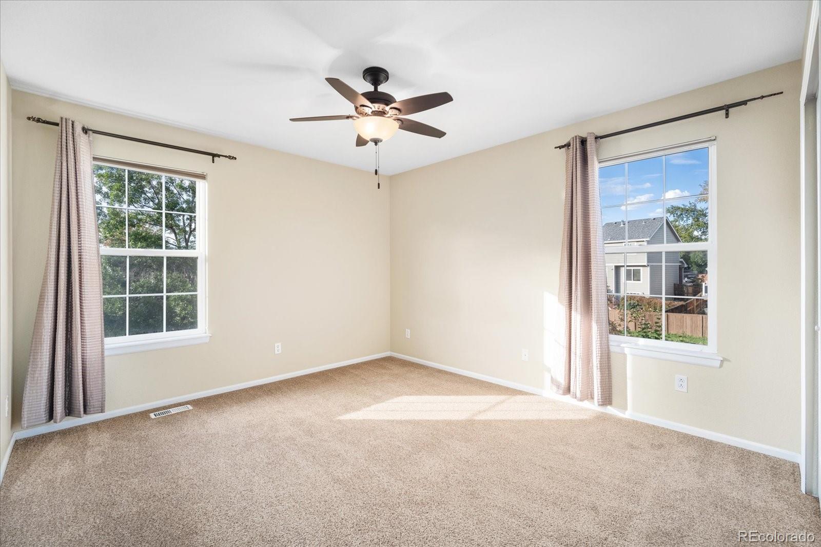 6115 Trailhead Road Highlands Ranch, CO 80130 - Photo 24 of 40 an empty room with windows and fan