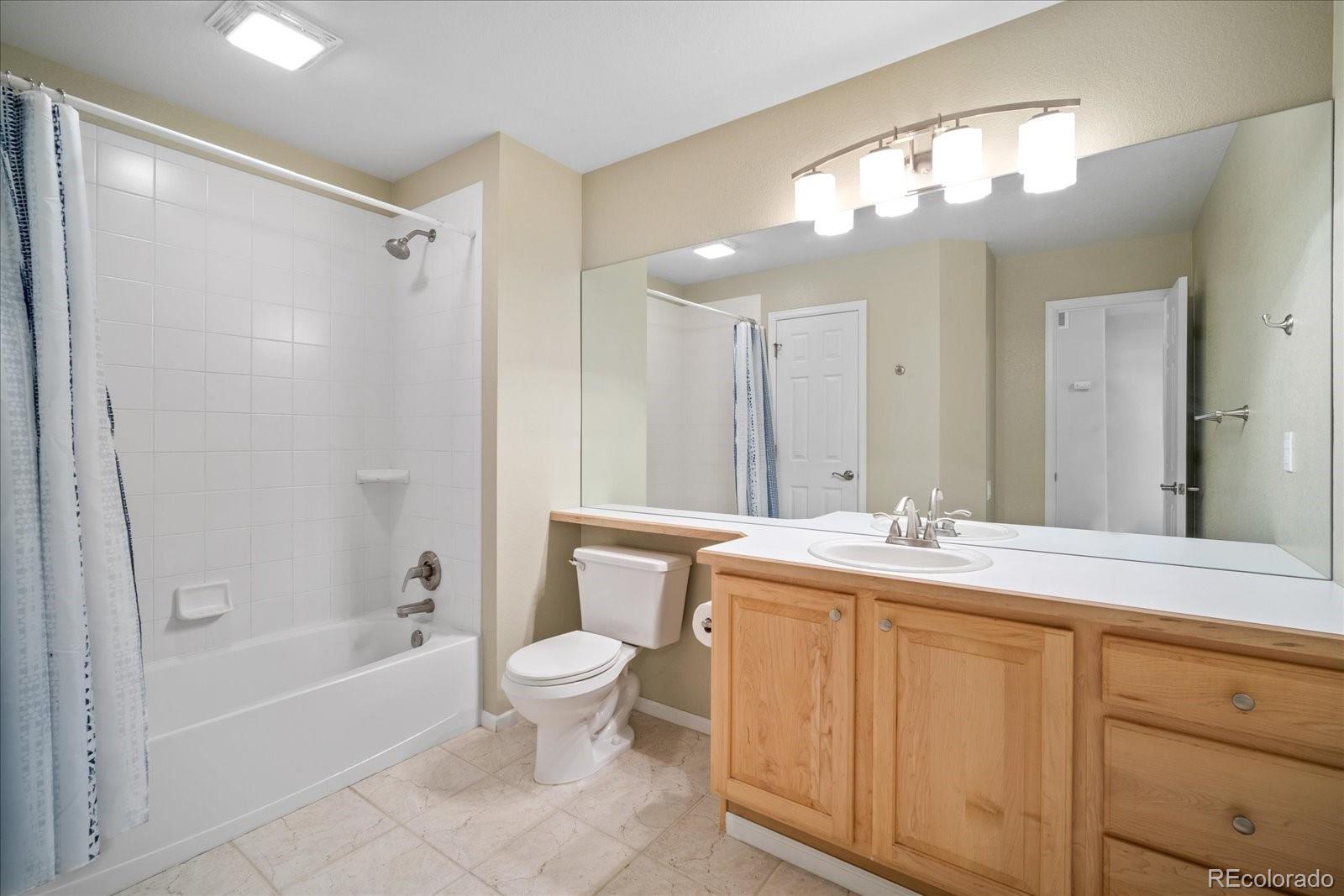 6115 Trailhead Road Highlands Ranch, CO 80130 - Photo 25 of 40 a bathroom with a sink a toilet and shower