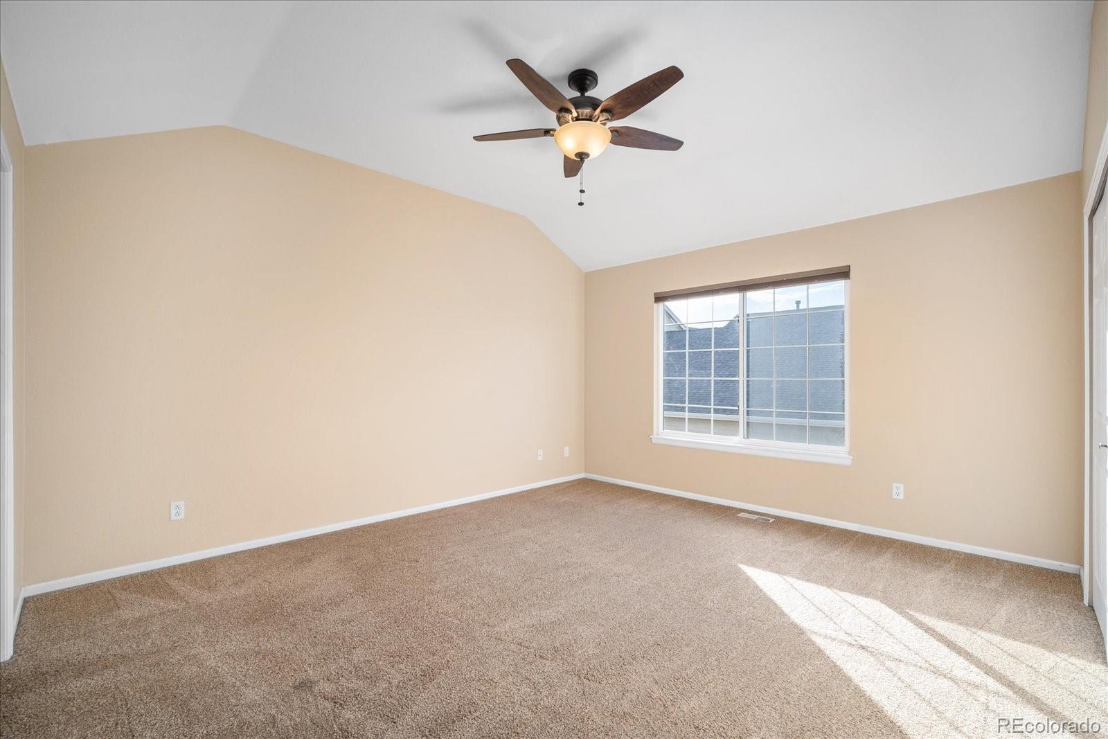 6115 Trailhead Road Highlands Ranch, CO 80130 - Photo 26 of 40 an empty room with a ceiling fan and window