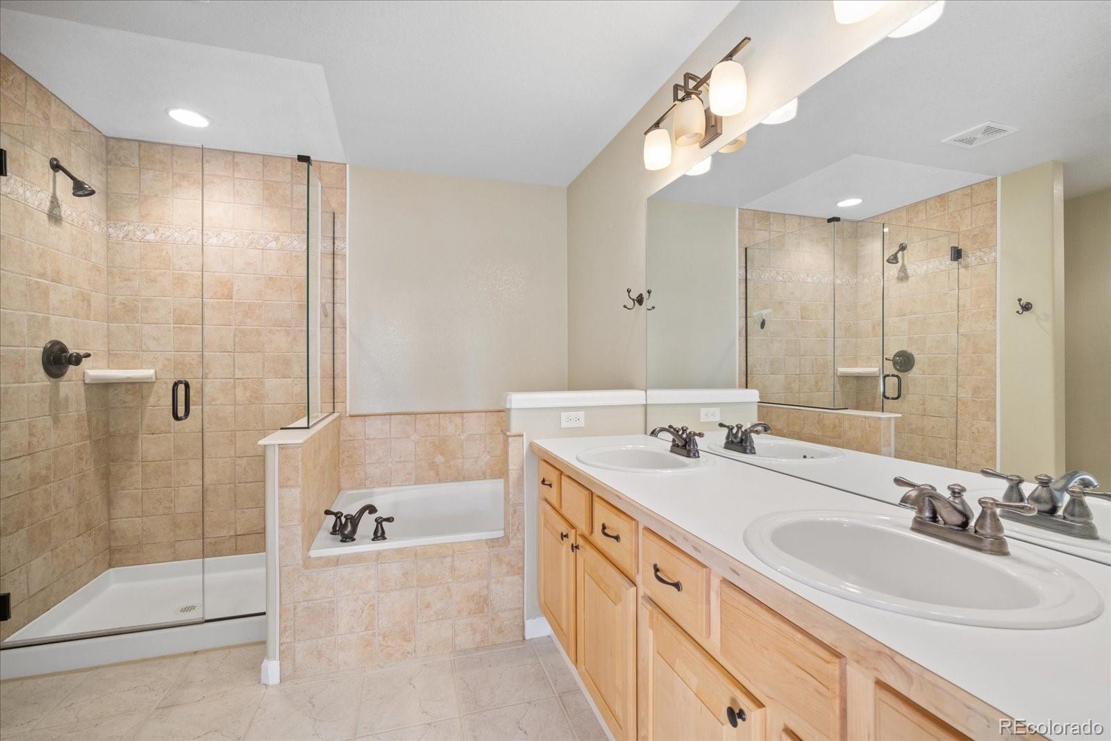 6115 Trailhead Road Highlands Ranch, CO 80130 - Photo 29 of 40 a spacious bathroom with a double vanity sink mirror and shower
