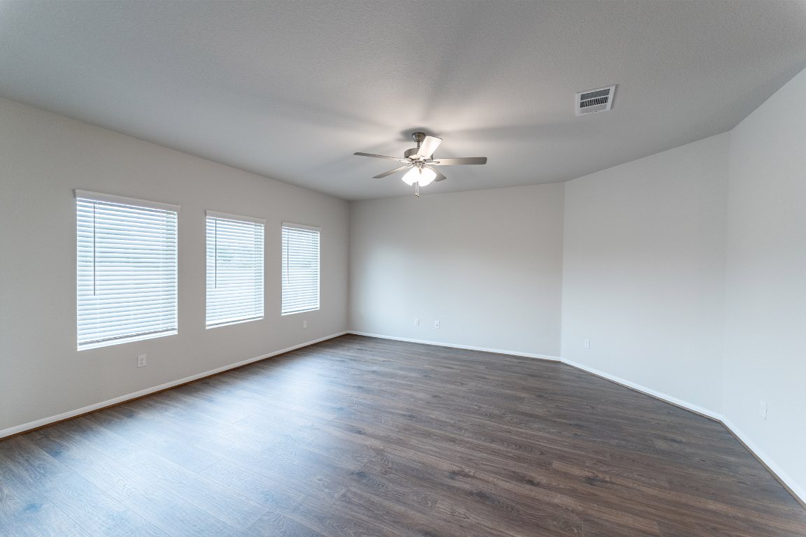 282 Denali Drive Kyle, TX 78640 - Photo 11 of 17 a view of an empty room with a window and wooden floor