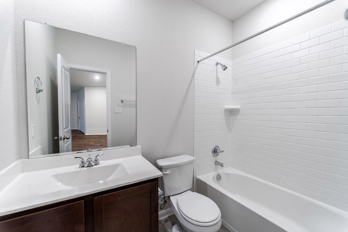 282 Denali Drive Kyle, TX 78640 - Photo 16 of 17 a bathroom with a sink a toilet and shower