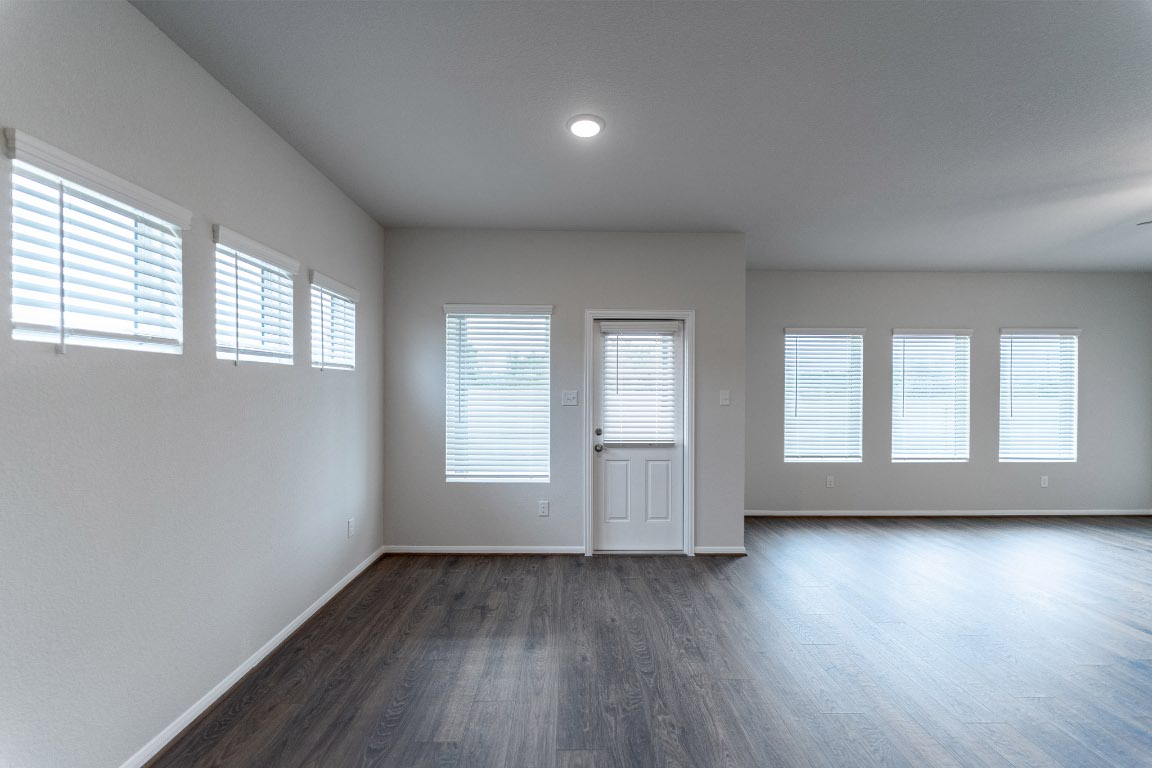 282 Denali Drive Kyle, TX 78640 - Photo 10 of 17 an empty room with wooden floor and windows