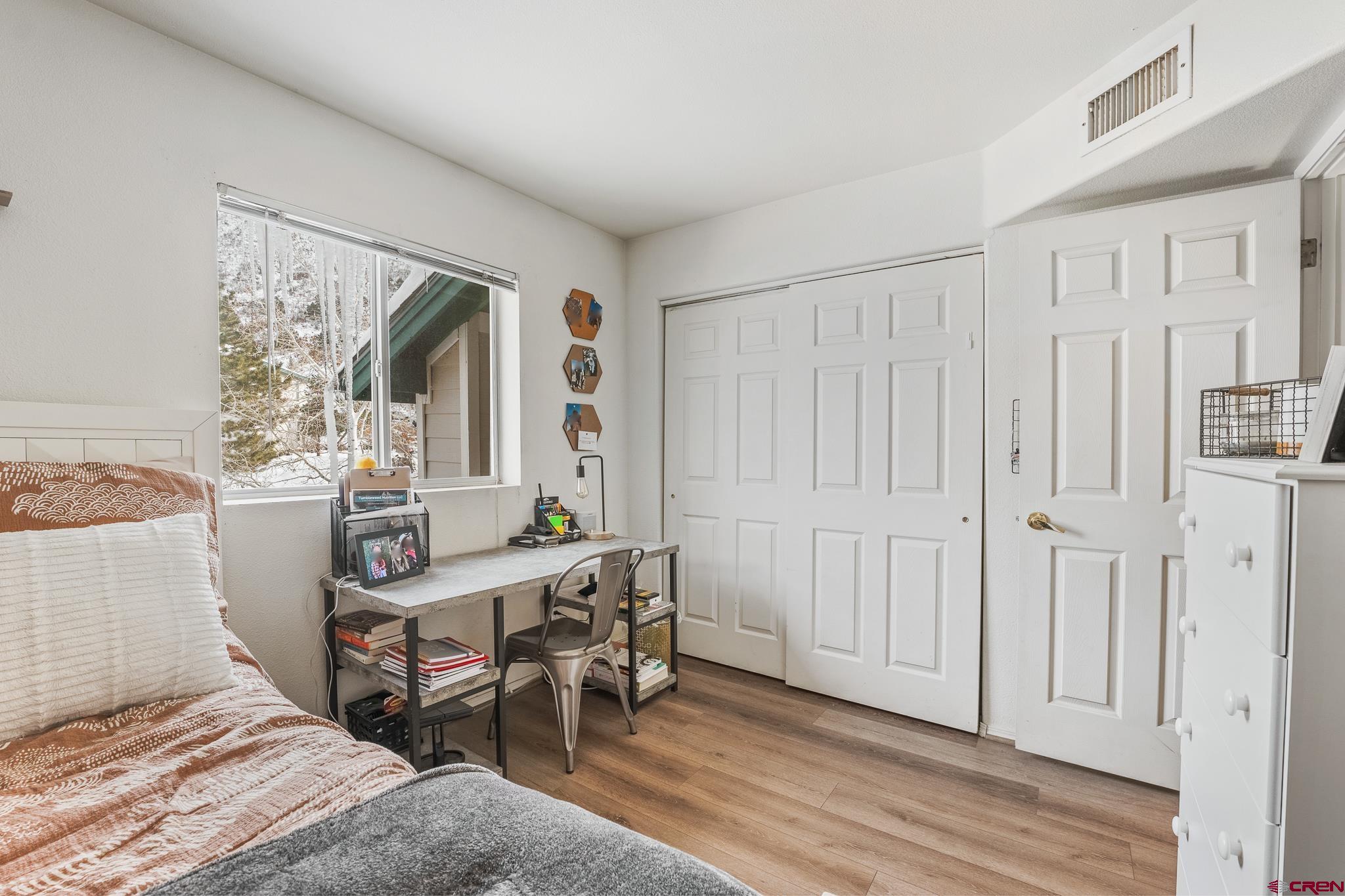 1100 Goeglein Gulch Road, Unit 206 Durango, CO 81301 - Photo 19 of 29 a view of a bedroom with furniture and window