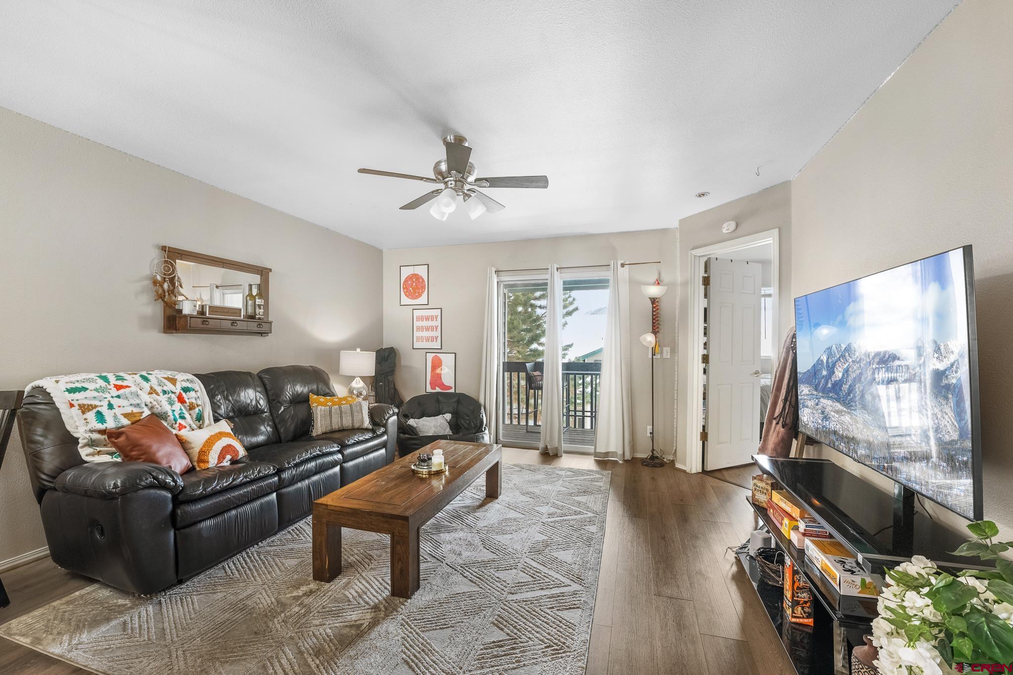 1100 Goeglein Gulch Road, Unit 206 Durango, CO 81301 - Photo 2 of 29 a living room with furniture and a flat screen tv
